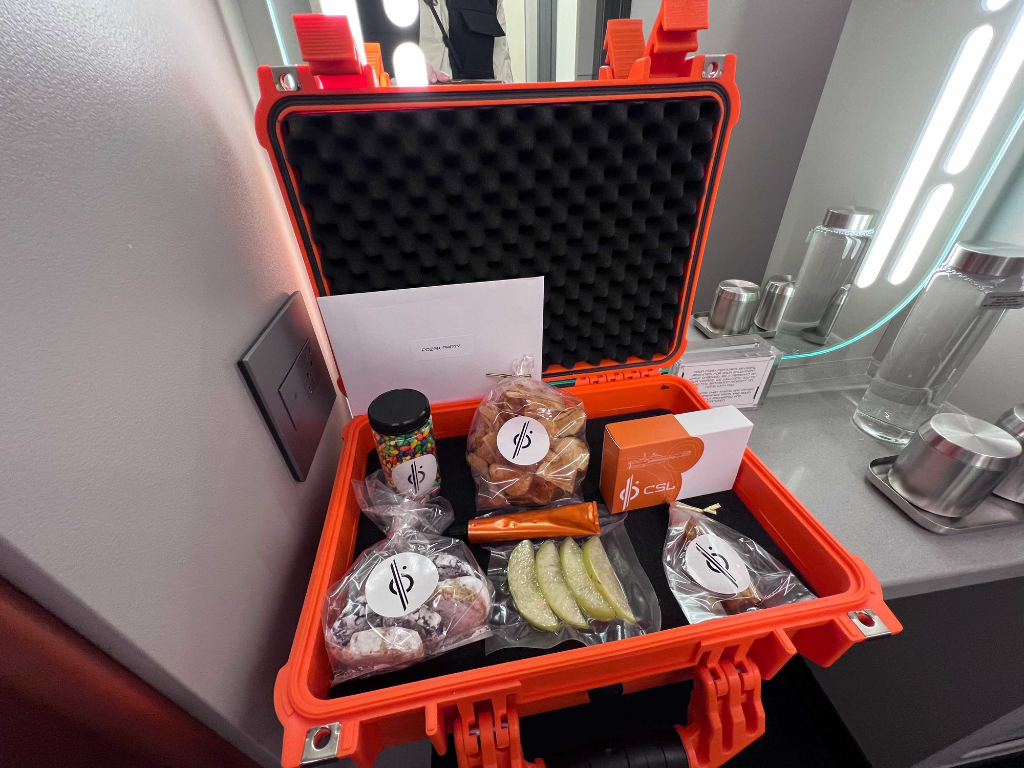 orange shipping container with space treats wrapped in plastic